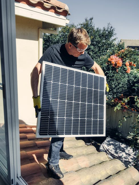 A worker installs a solar panel on a roof, promoting clean and renewable energy.